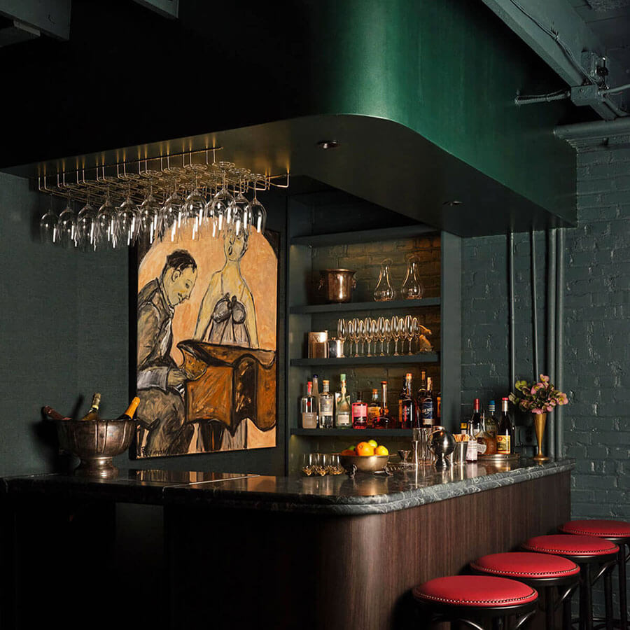speakeasy-style room with a curved dark marble bar, red-trimmed stools, green canopy with hanging stemware, shelves of bottles and glassware, and a pianist painting—BKS private bar.