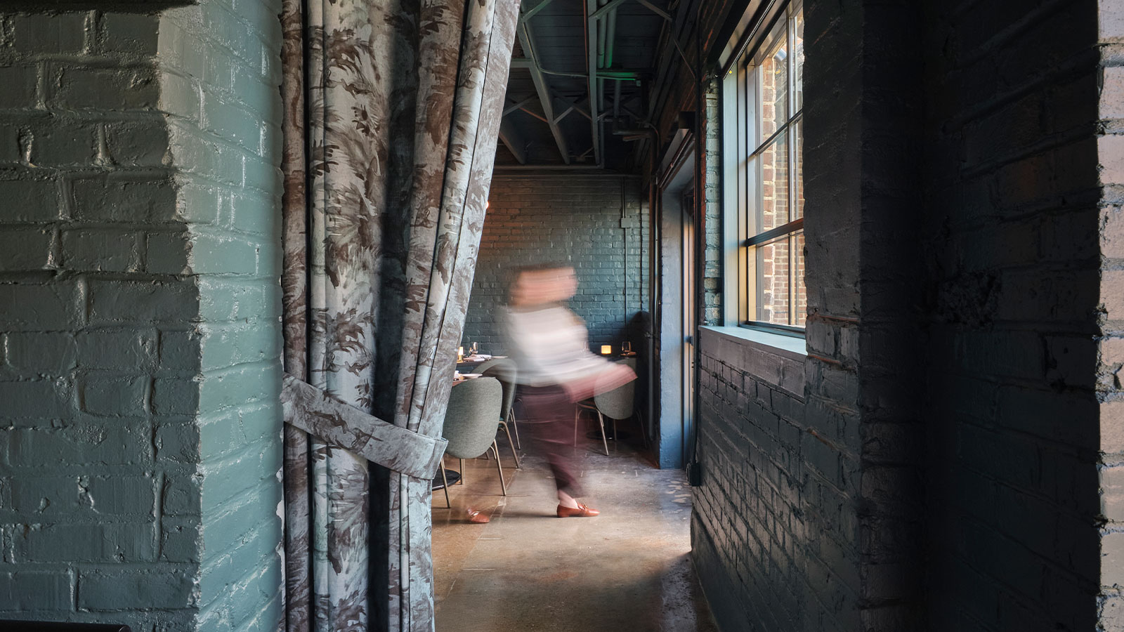 Blurry shot of a staff member walking through Felicia Suzanne Restuarants in Downtown Memphis, Tennessee.