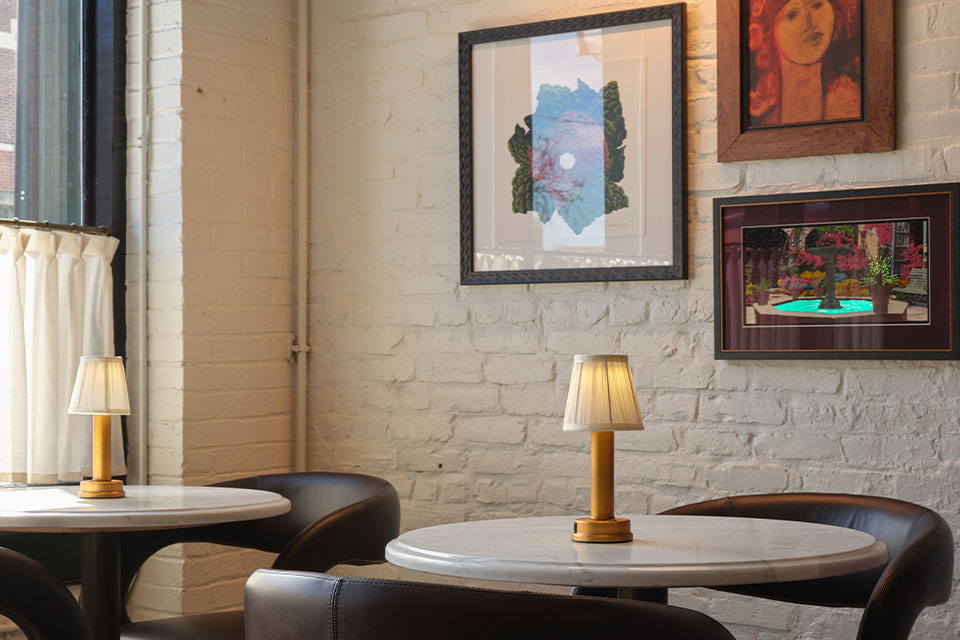 Inside Felicia Suzannes Restaurant in Downtown Memphis, with a wall of art.